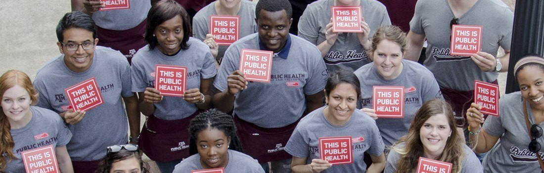 Individuals holding a "This is public health" sign